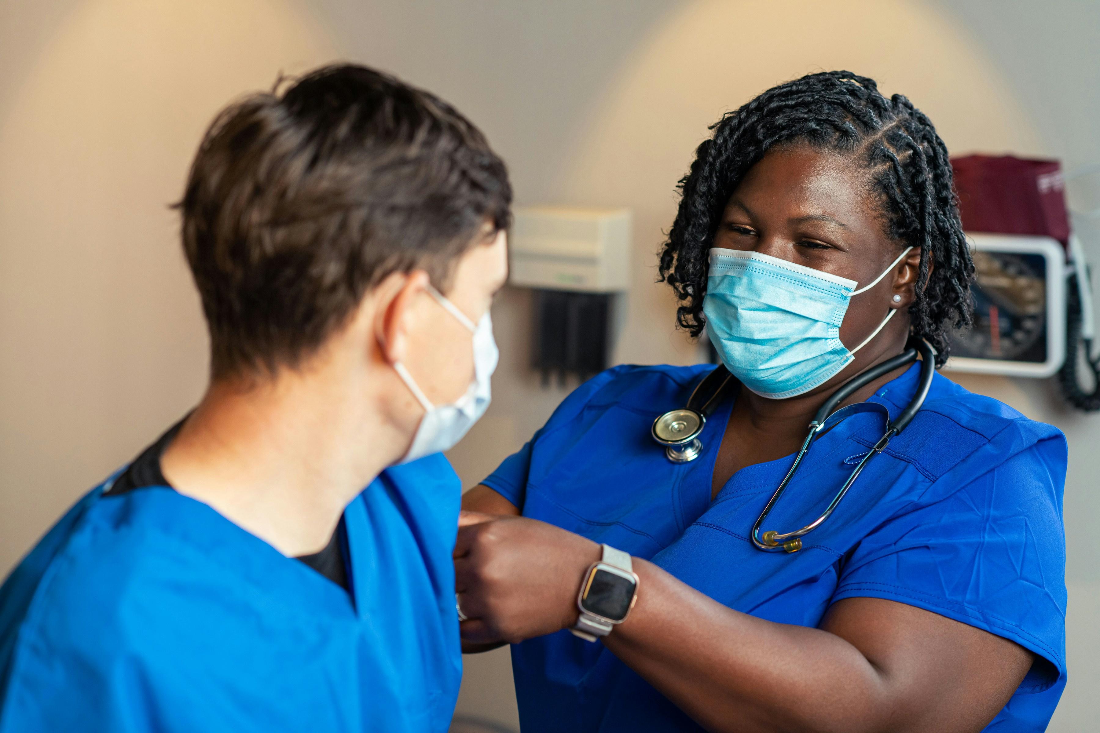 Registered Nurse reviewing care needs on a tablet